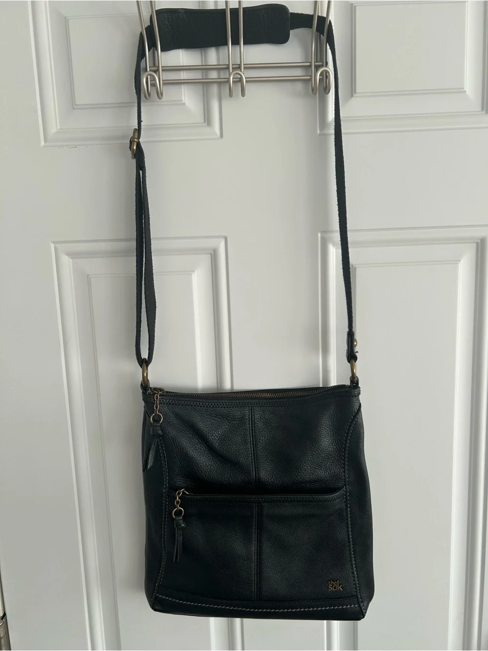 The Sac Iris Black Pebbled Leather Crossbody Bag Adjustable Strap Brass Hardware
